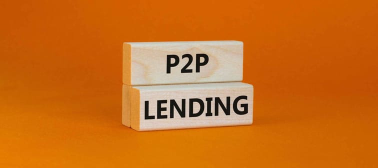 P2P peer to peer lending symbol. Concept words P2P lending on wooden blocks on a beautiful orange background. Business and P2P peer to peer lending concept. Copy space.