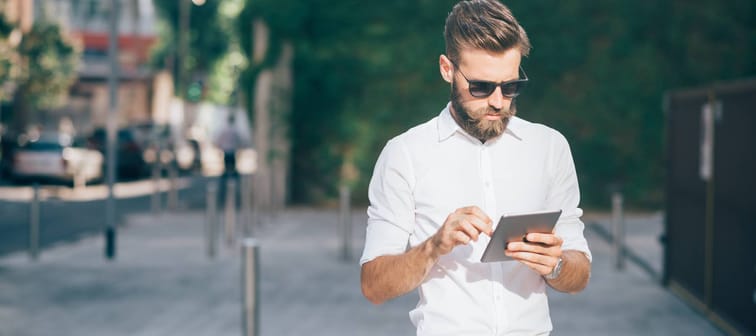 young businessman bearded outdoor using tablet - remote working, technology, communication concept