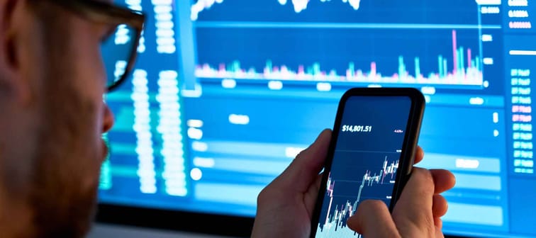 Business man trader investor analyst using mobile phone app analytics