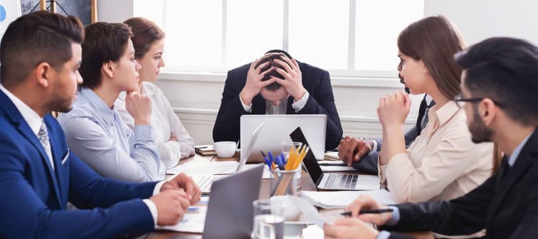 Stressed boss having problem at business meeting in office