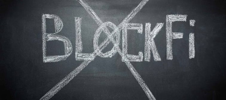 BlockFi is written in white chalk on the black board and crossed out. Close-up. The concept of the bankruptcy and collapse of the cryptocurrency exchange BlockFi