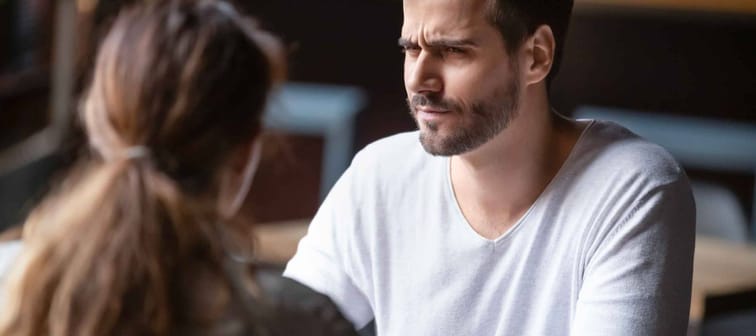 Doubting dissatisfied man looking at woman, bad first date concept,