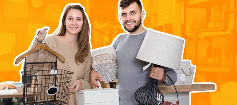 a smiling couple holding up finds at an estate sale