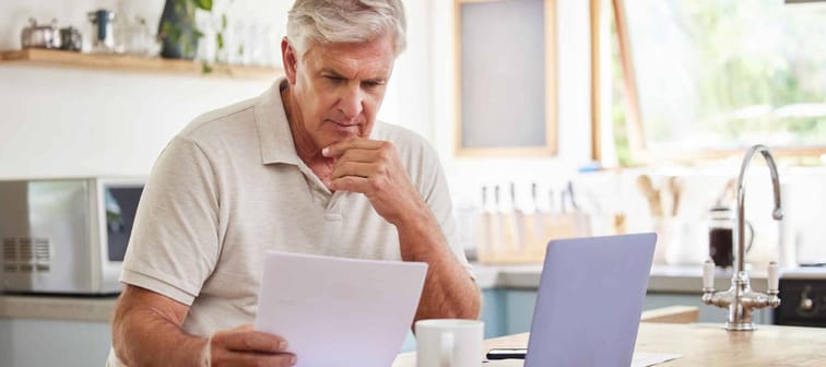 Planning, documents and finance with elderly man on laptop i