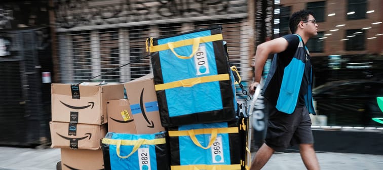 An Amazon worker moves boxes on Amazon Prime Day in the East Village of New York City, July 11, 2023.