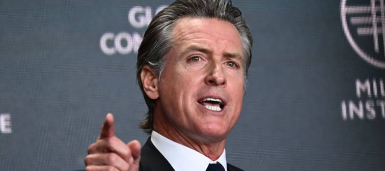 California Governor Gavin Newsom seen with a fierce look on his face, pointing his finger.