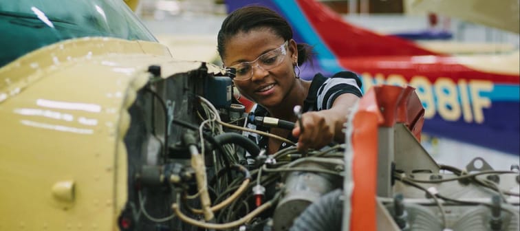 An aircraft mechanic student practices her craft.