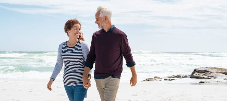 A couple walking on the beach.