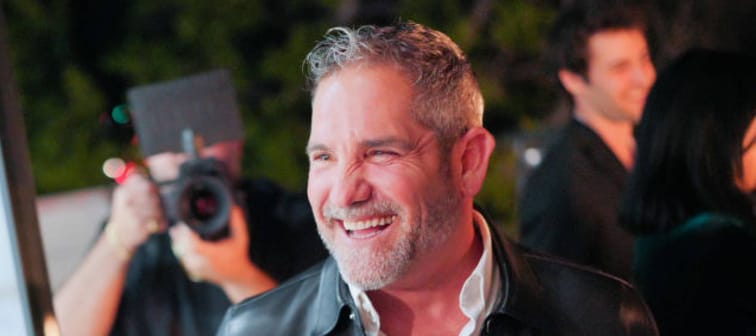 Real estate investor Grant Cardone smiles big at a backyard party.