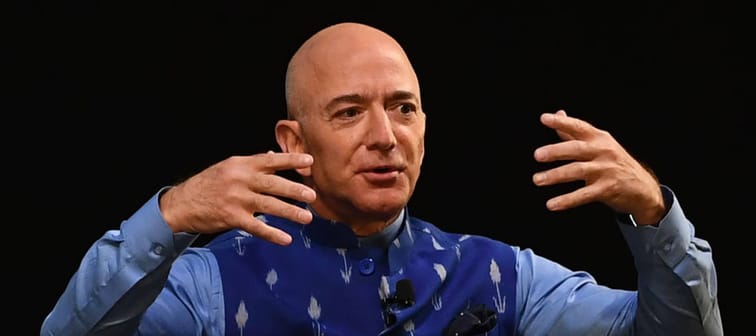 CEO of Amazon Jeff Bezos gestures as he addresses the Amazon's annual Smbhav event in New Delhi .