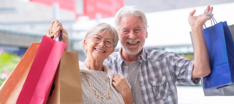 An older couple enjoy a day of shopping.