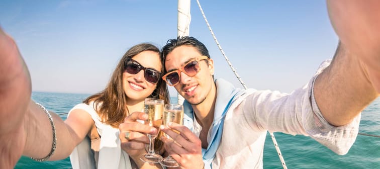 wealthy young Caucasian couple posing for a selfie on a yacht