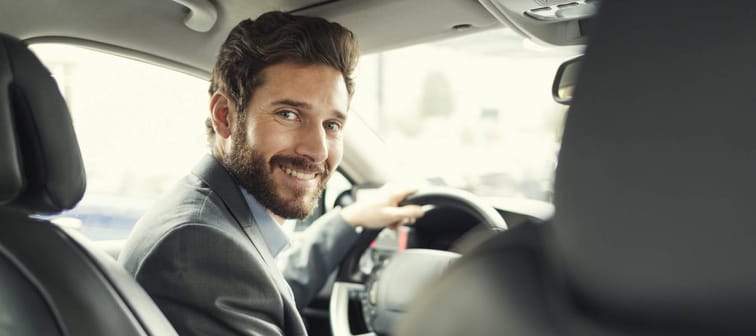 Portrait of man in his car. looking camera