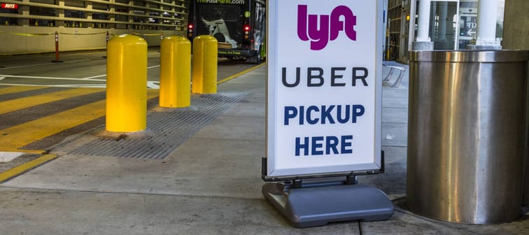 Indianapolis - Circa July 2017: Ride sharing companies Lyft and Uber pickup spot at the airport. Lyft and Uber have replaced many Taxi cabs for transportation I