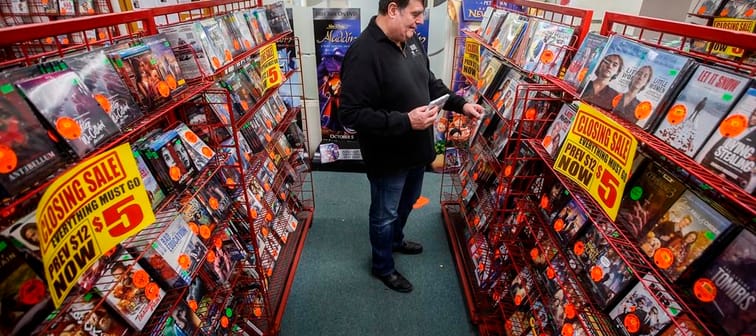 Glen Fuhl, president and CEO of Video King, is photographed as he organizes shelves in one of his stores in Winnipeg Thursday, March 7, 2024. Fuhl is planning to close up shop after forty yea