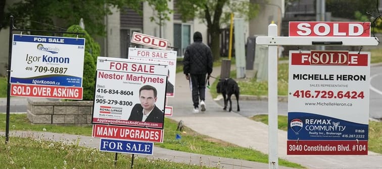 Experts say title and mortgage fraud are fast growing in Canada and homeowners should take steps to protect their properties &mdash; and their identities. A person walks past multiple for-sal