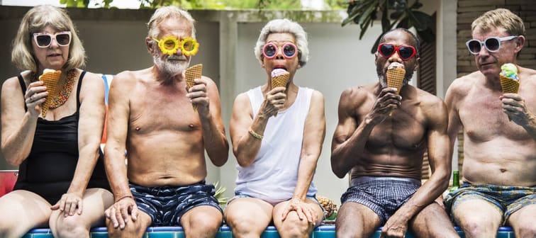 A group of older folks enjoying ice cream by the pool.