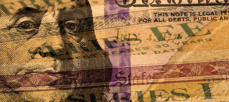 Double exposure one hundred dollar bill and U.S. treasury savings bond