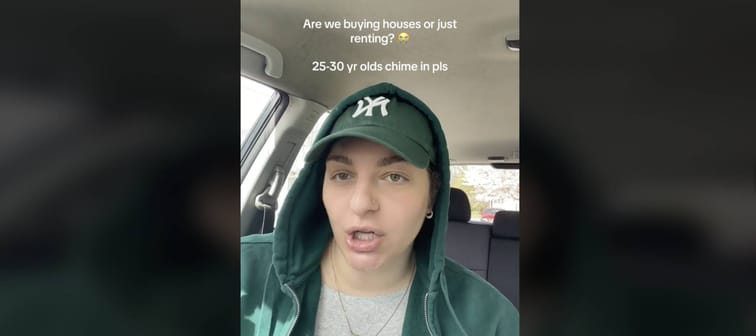 Young woman seen sitting in front seat of car, talking directly to the camera.