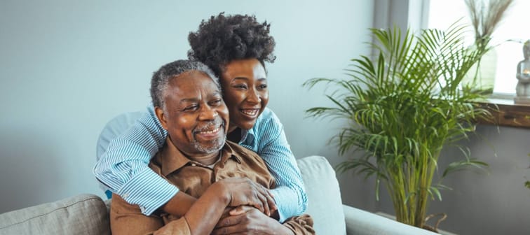 portrait of Black father and daughter laughing and being happy