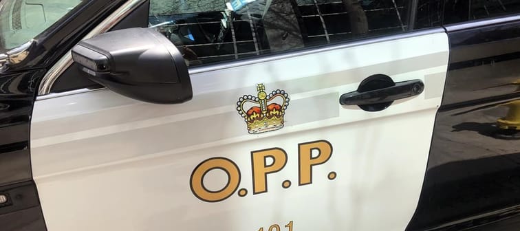 An Ontario Provincial Police vehicle sits in downtown Toronto on Tuesday, April 11, 2023. Ontario Provincial Police are facing tough questions about their search for a missing trucker whose r