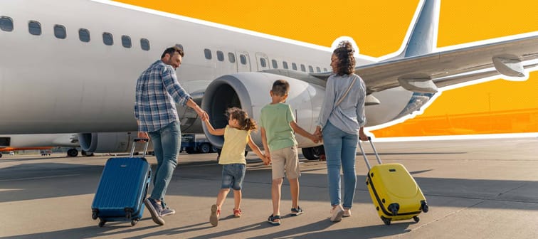 happy family rolling suitcases towards a small plane