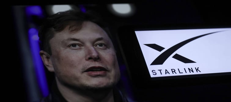 Elon Musk next to Starlink logo.