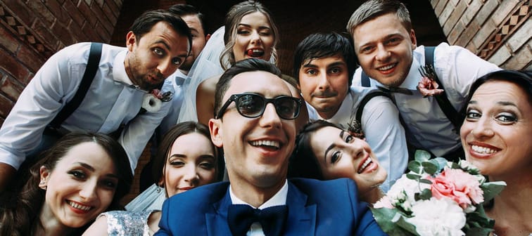 Handsome groom selfie with fun beautiful bridesmaids & groomsmen