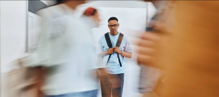 sad university student, black man and mental health problems in busy college