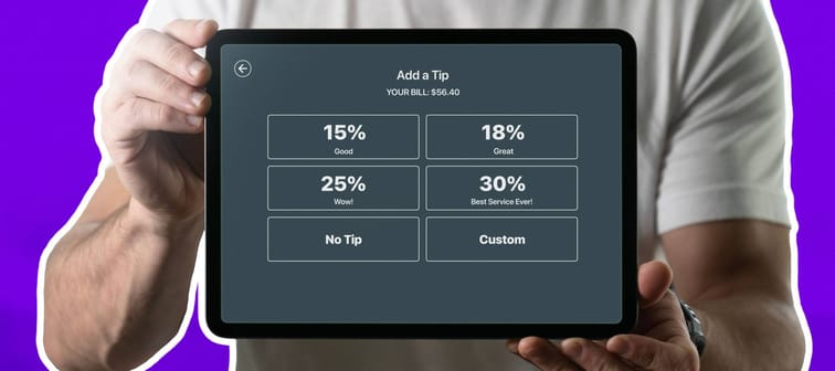 Male server holding an Ipad with a tipping option on the screen