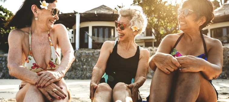 Three women enjoy their time on the beach.