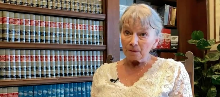 Woman in 70s talking about being fired over scary customer demanding fraudulent transactions