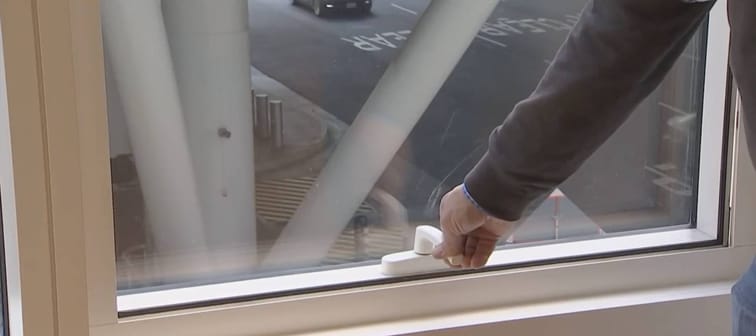 A resident use the window in Millennium Tower.