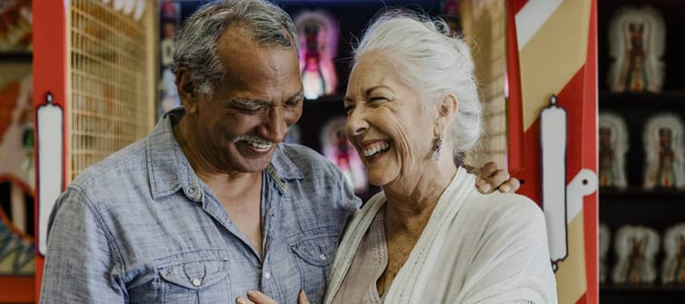 An older couple enjoy their time at an arcade.