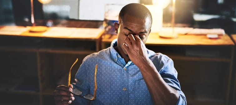 Black man in business, night and headache with stress and vision problem