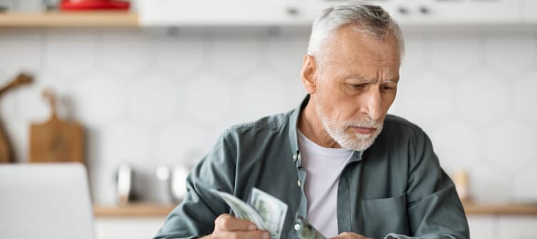 Senior man counting bills