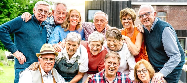 Large group of happy senior men and women taking selfie pic at private villa