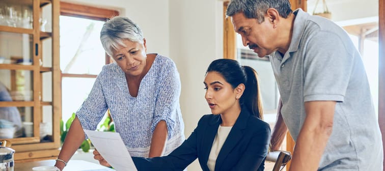 An older couple getting advice from a financial planner.