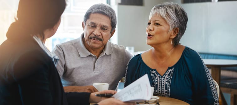 An older couple speak with an adviser.