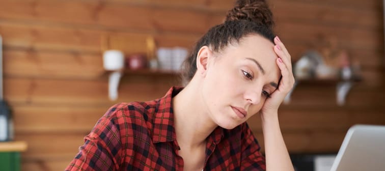 Young tired woman trying to worried about finances