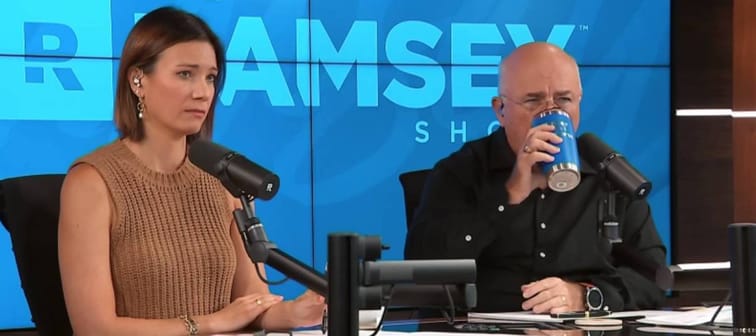 Dave Ramsey sips from coffee tumbler while sitting on set of his radio show with his cohost Rachel Cruze.