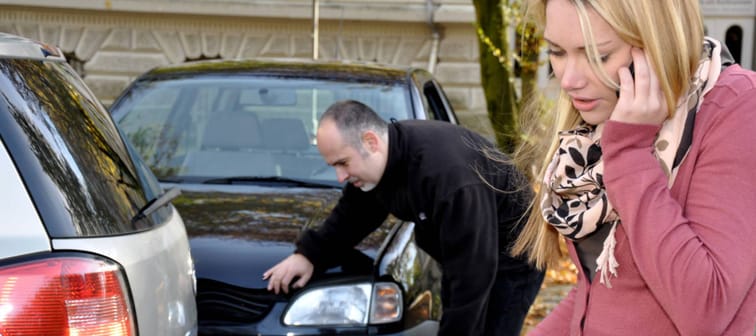 Woman calling police after car accident.