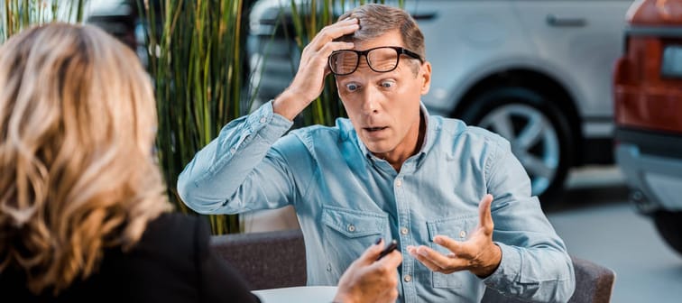 A shocked customer at a car dealership.