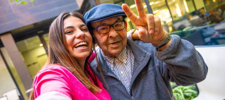 A young woman and elderly man enjoy their time together.