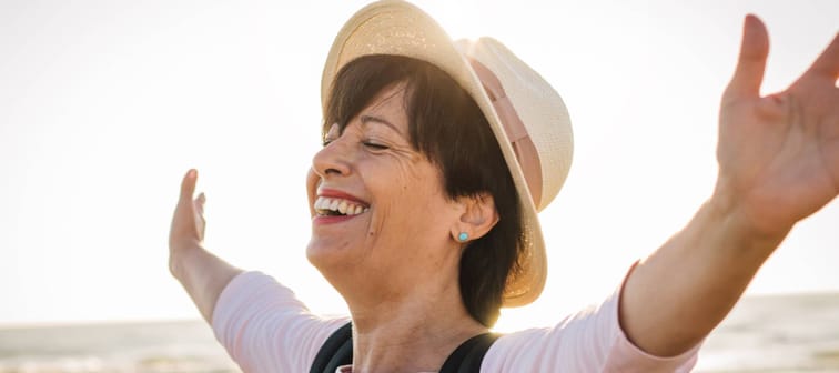 Joyful woman enjoying the freedom of the beach