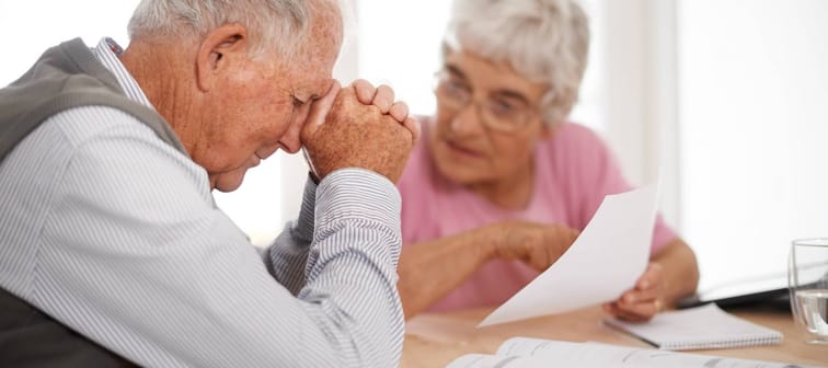 Senior man and woman going over paper documents