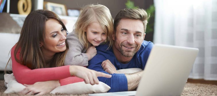 Young family looking at laptop together