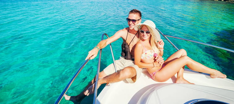 Romantic happy couple in love relaxing on a yacht at sea