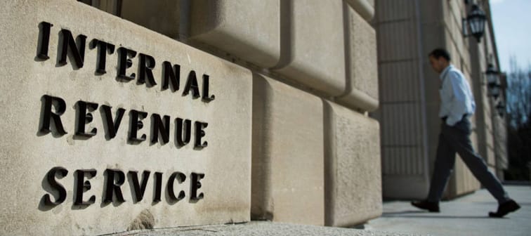 A man walks into the Internal Revenue Service building in Washington, DC.