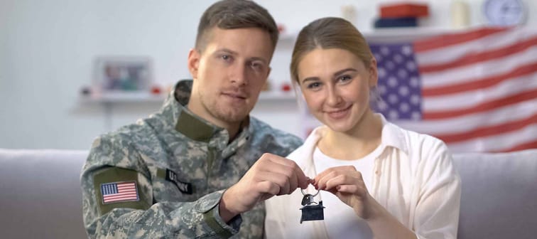American male soldier and his wife holding house key reward for military service